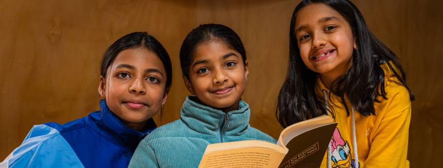 Image of three children smiling 